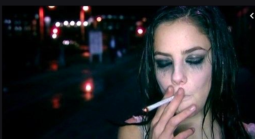 Girl smoking a cigarette crying with mascara stains down her eyes after UHO