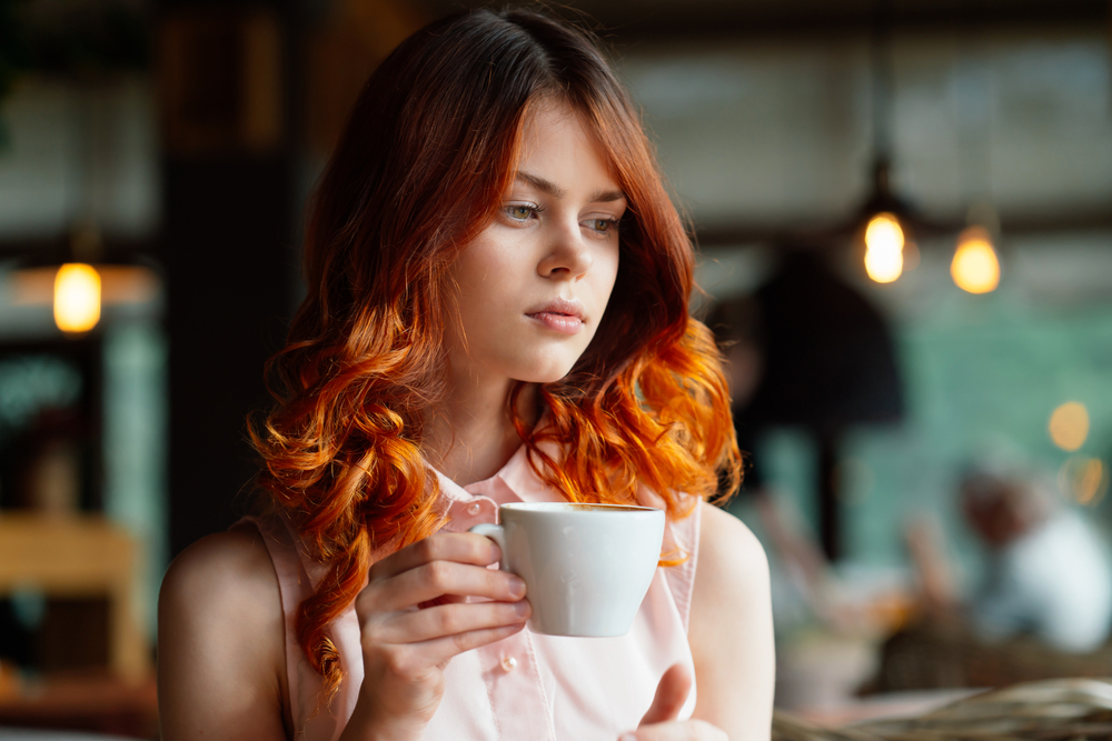 Girl in a cafe looking despondent