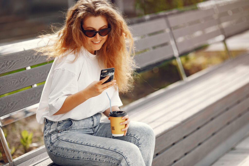 woman on park bench texting 