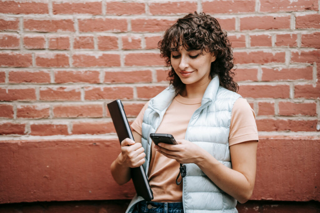 woman with curly mullet texting 