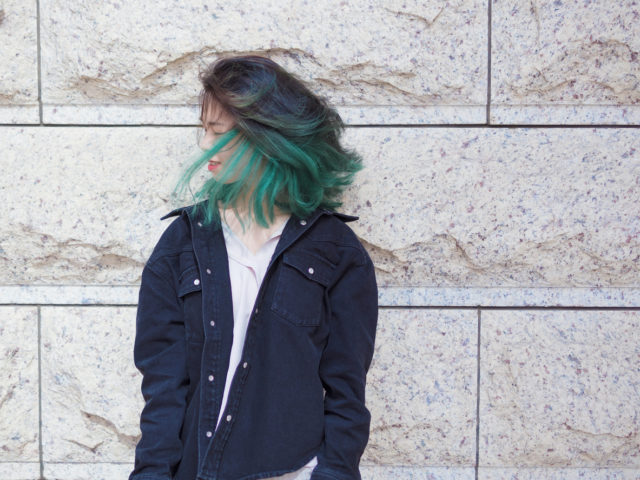 Woman with green hair posing outdoor
