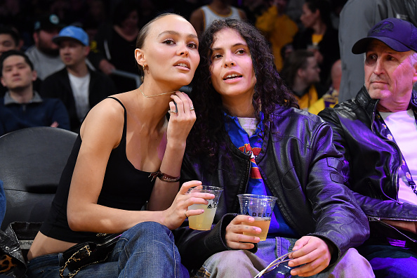 Lily-Rose Depp and 070 Shake attend a basketball game.