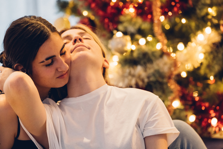 Lesbian couple in front of Christmas tree