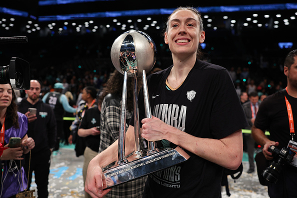 Breanna Stewart of the New York Liberty celebrates with the WNBA Championship Trophy