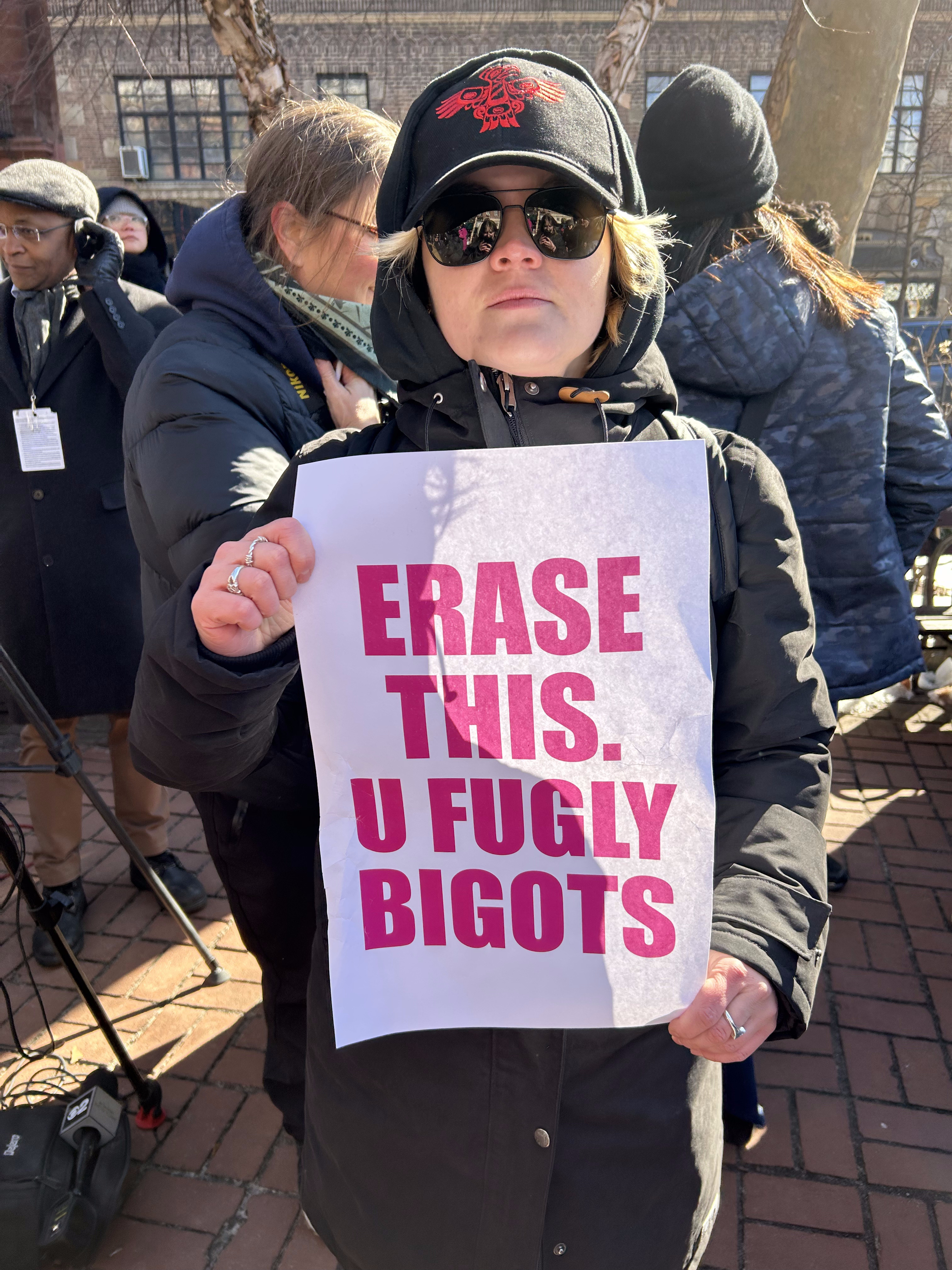 Protestor holds sign reading, "Erase this. U fugly bigots" at Stonewall National Monument 2.14.2025