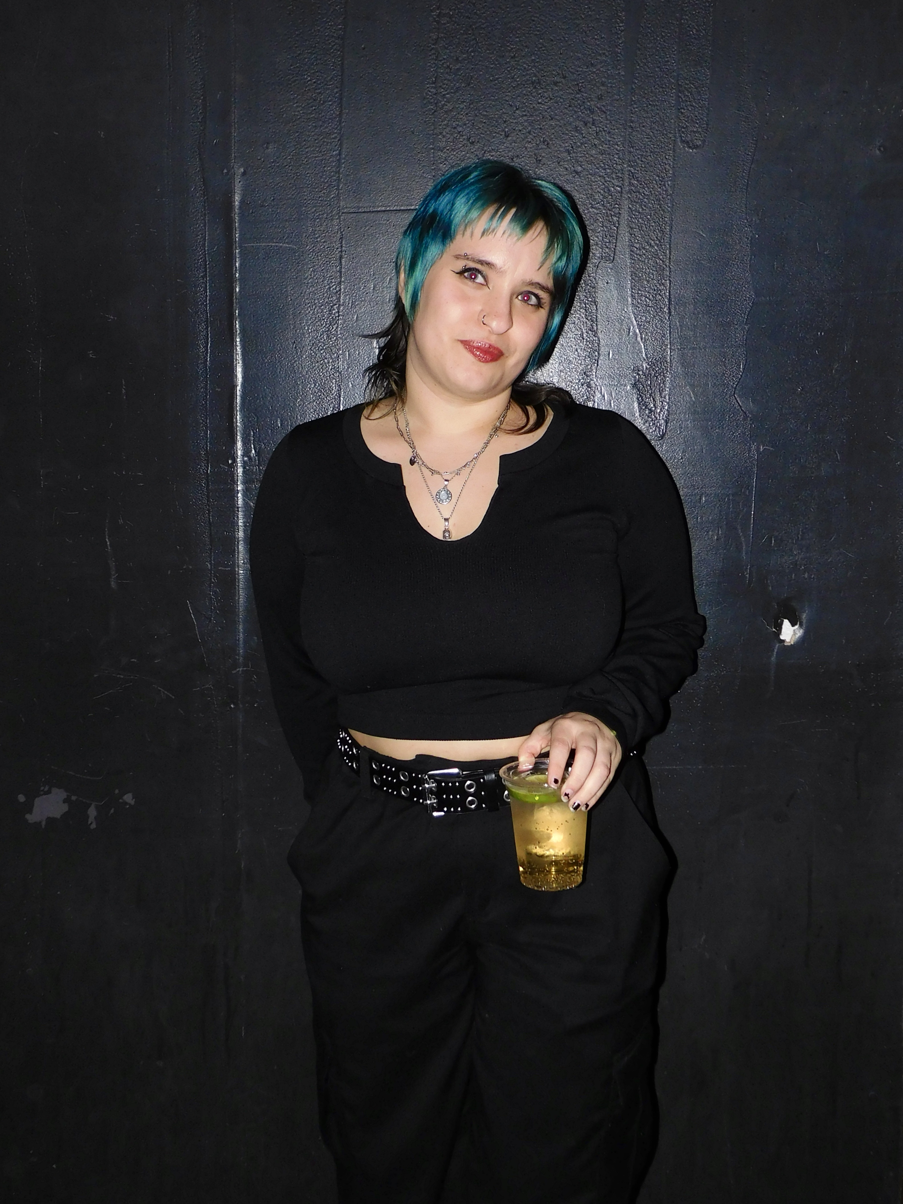 Abby in a black top and black jeans