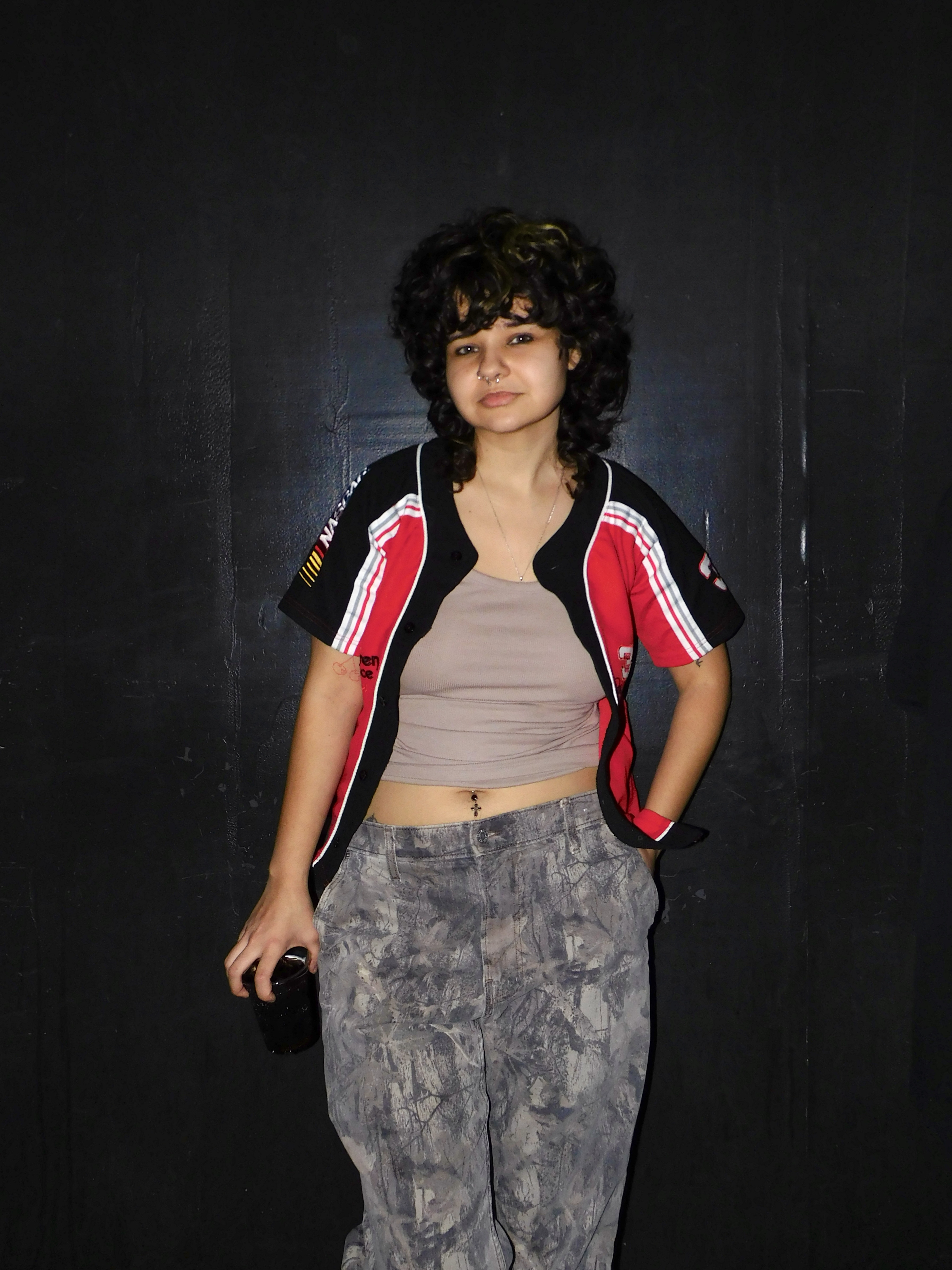 Gia in a gray top and camo pants