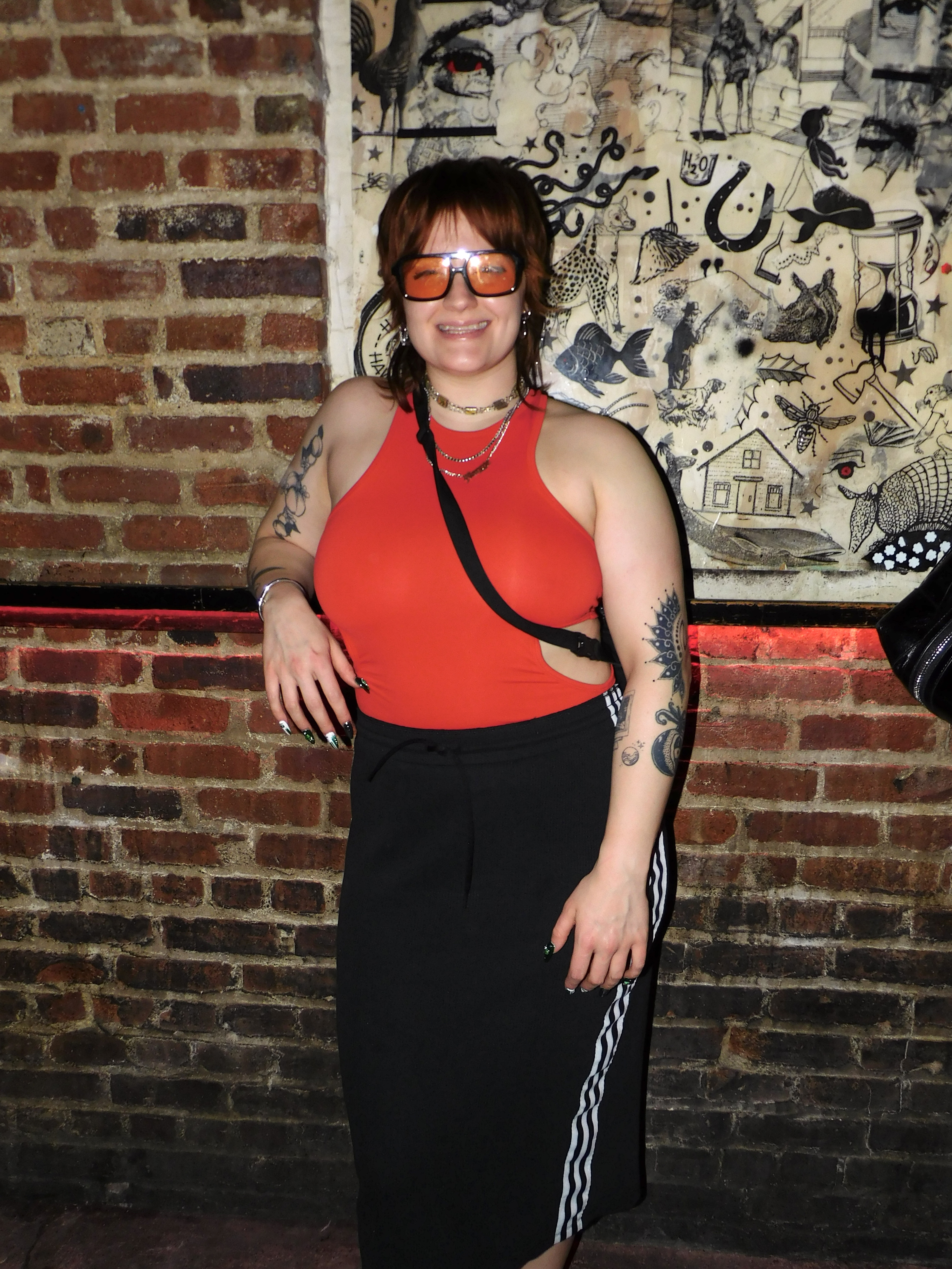 Maggie in a red top and track pants