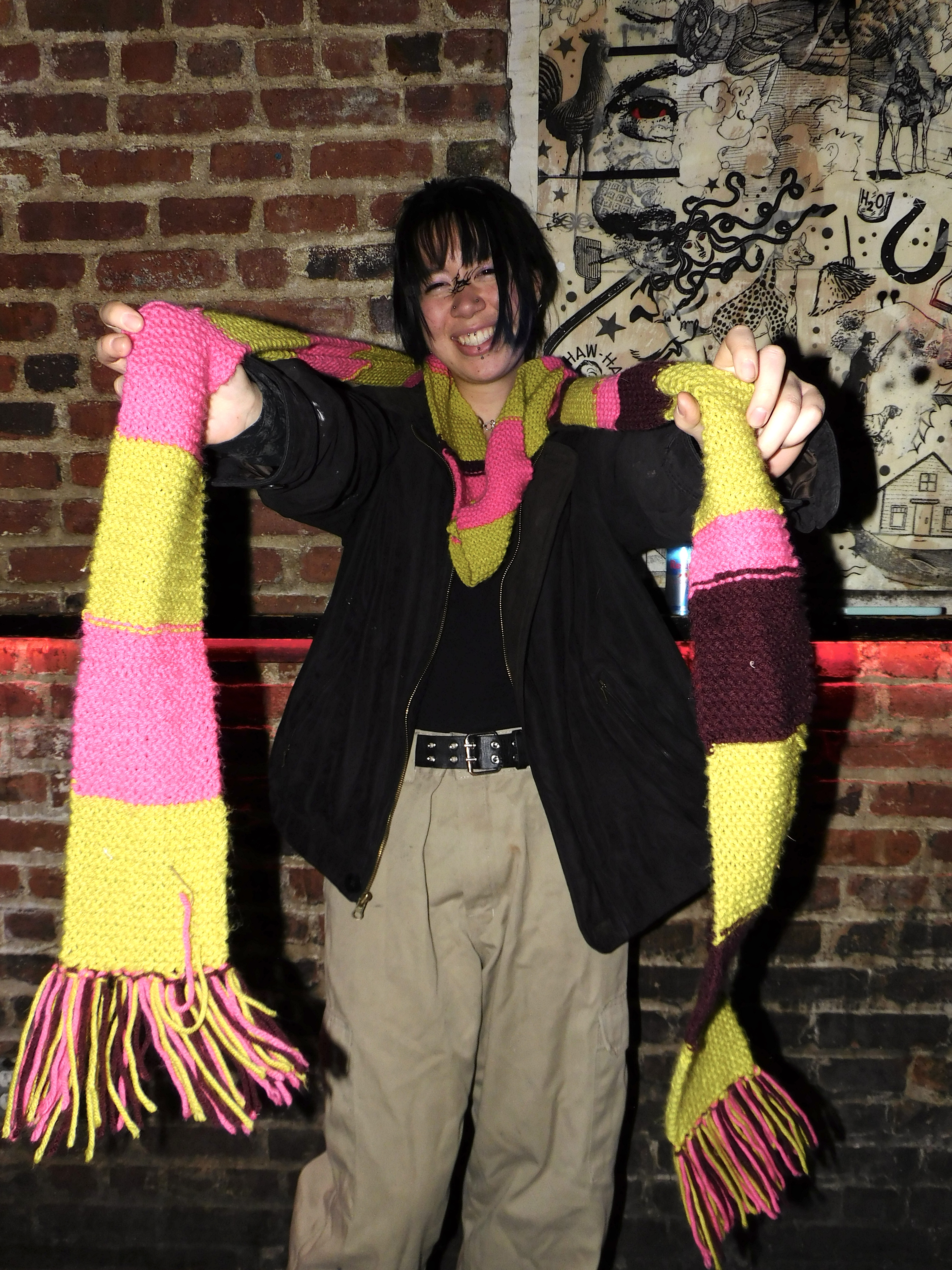 Thalia in a black top, khaki bottoms, and scarf