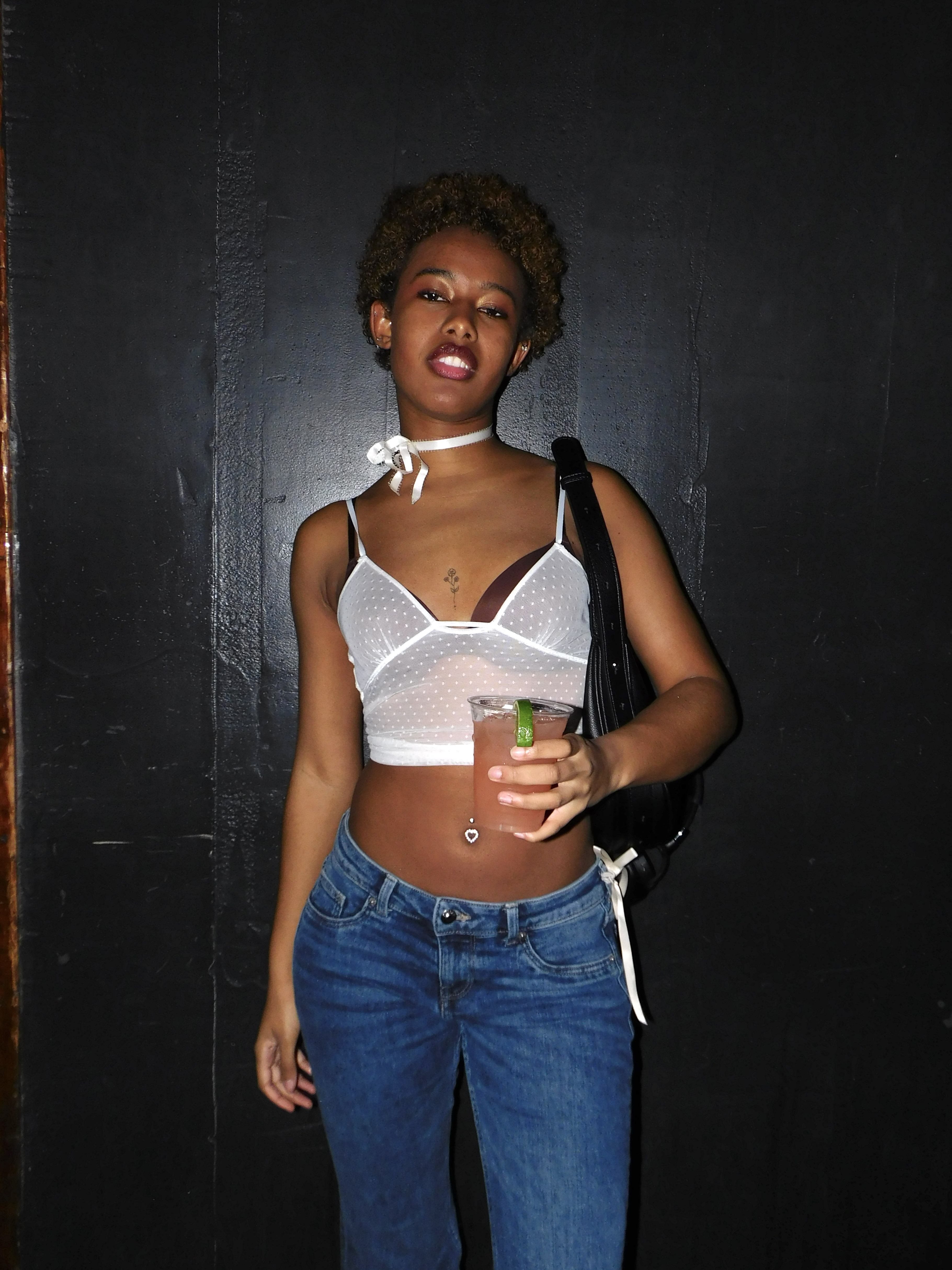Wave in a white crop top and blue jeans