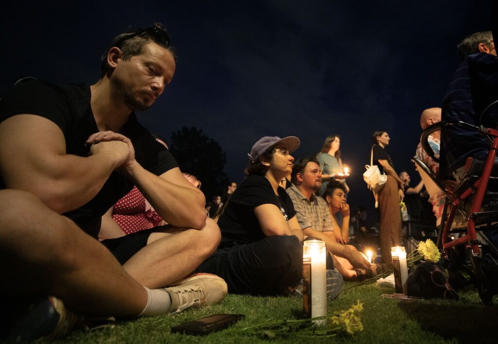 Mourners gather for a candlelight vigil to honor the victims of the shooting at Venture-N in Tucson. 