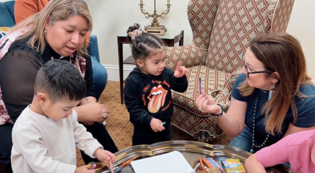  “Faith on the Front Lines” Dr. Rev Isabel Marquez-E a nd Dr. Rev Rachel Griffin Allison entertain migrant children in Dallas. Photo courtesy of Wow Films